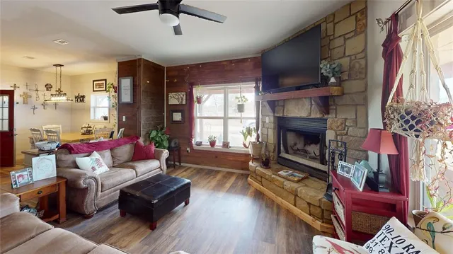 a kitchen with stainless steel appliances granite countertop a dining table chairs refrigerator and microwave