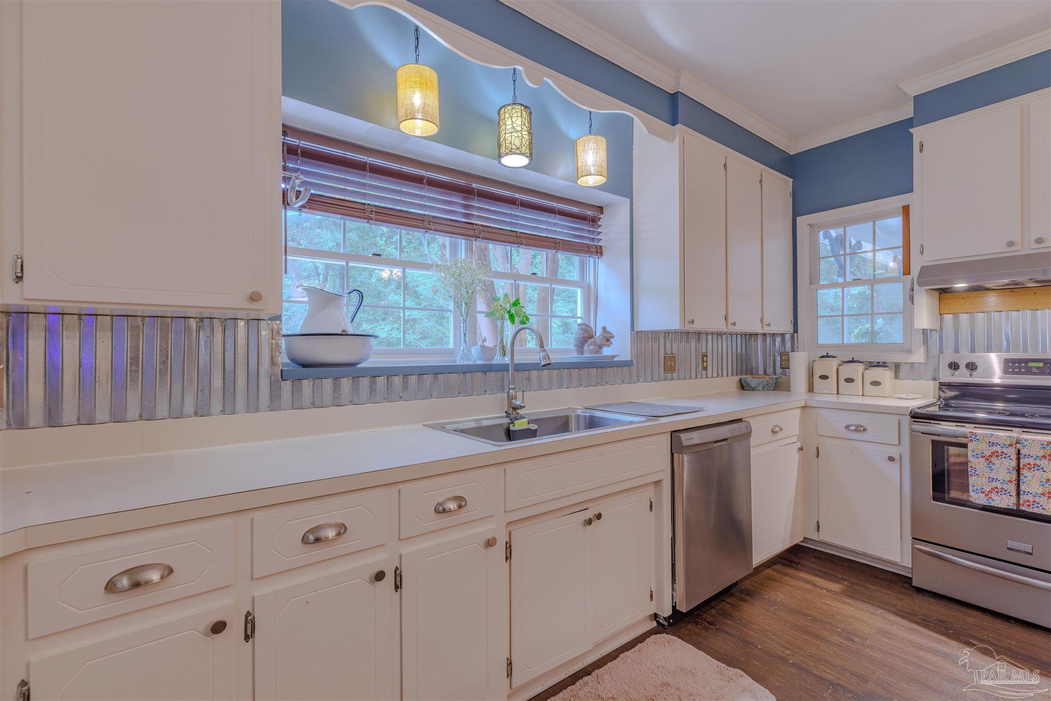 5049 Guernsey Road Pace, FL 32571 - Photo 24 of 61 a kitchen with a sink cabinets and window