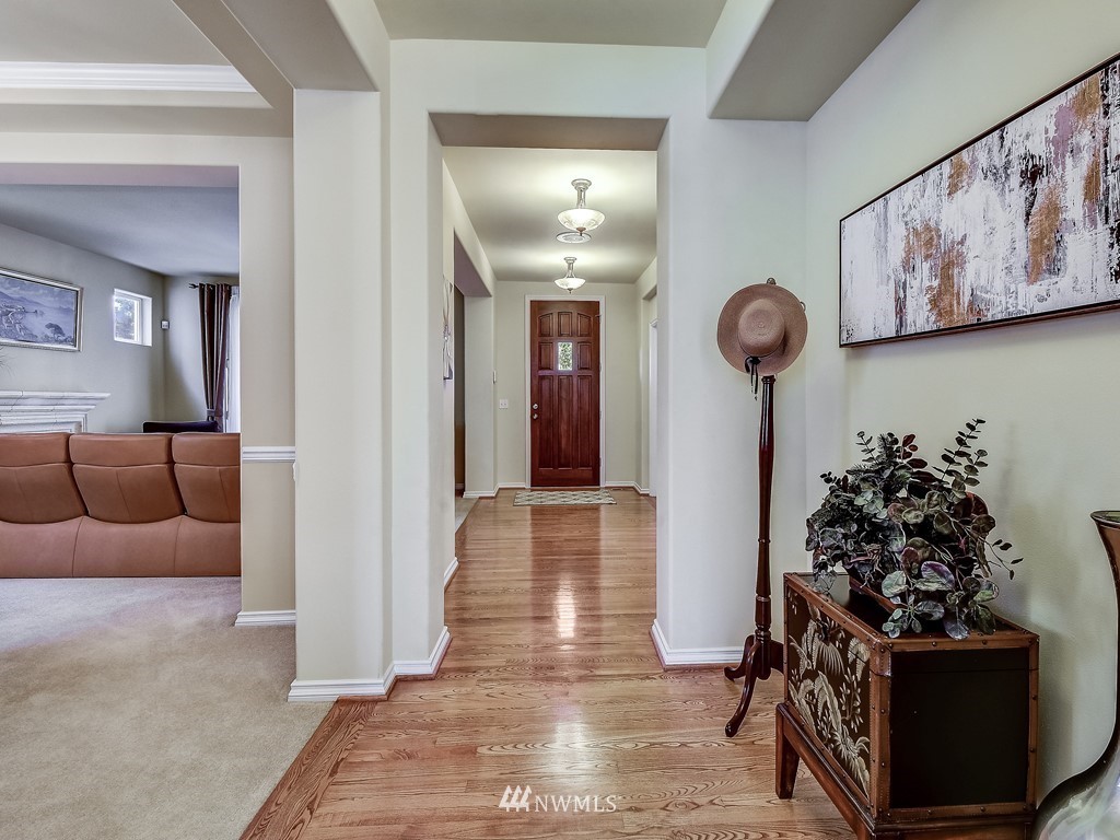17070 Parkside Way Southeast Renton, WA 98058 - Photo 3 of 25 a view of a hallway with a couch and chandelier