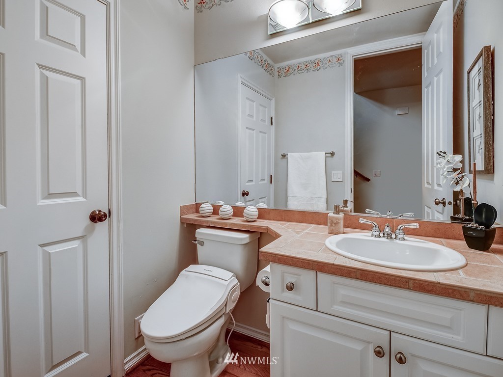 17070 Parkside Way Southeast Renton, WA 98058 - Photo 24 of 25 a bathroom with a toilet sink and mirror