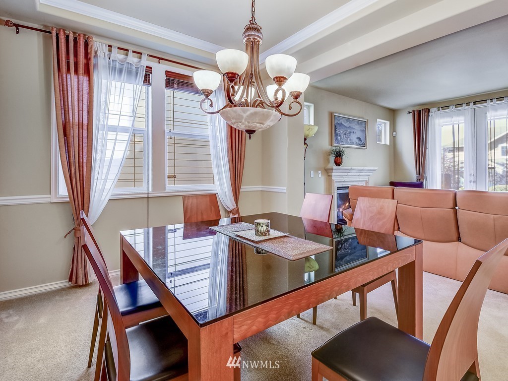 17070 Parkside Way Southeast Renton, WA 98058 - Photo 7 of 25 a view of a dining room with furniture window and chandelier