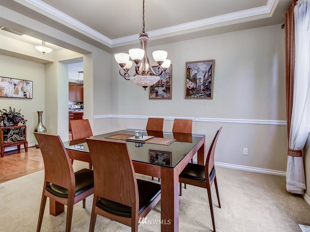 17070 Parkside Way Southeast Renton, WA 98058 - Photo 8 of 25 a view of a dining room with furniture and chandelier