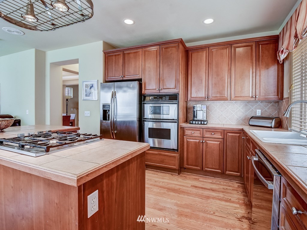 17070 Parkside Way Southeast Renton, WA 98058 - Photo 9 of 25 a kitchen with a stove a sink and a refrigerator