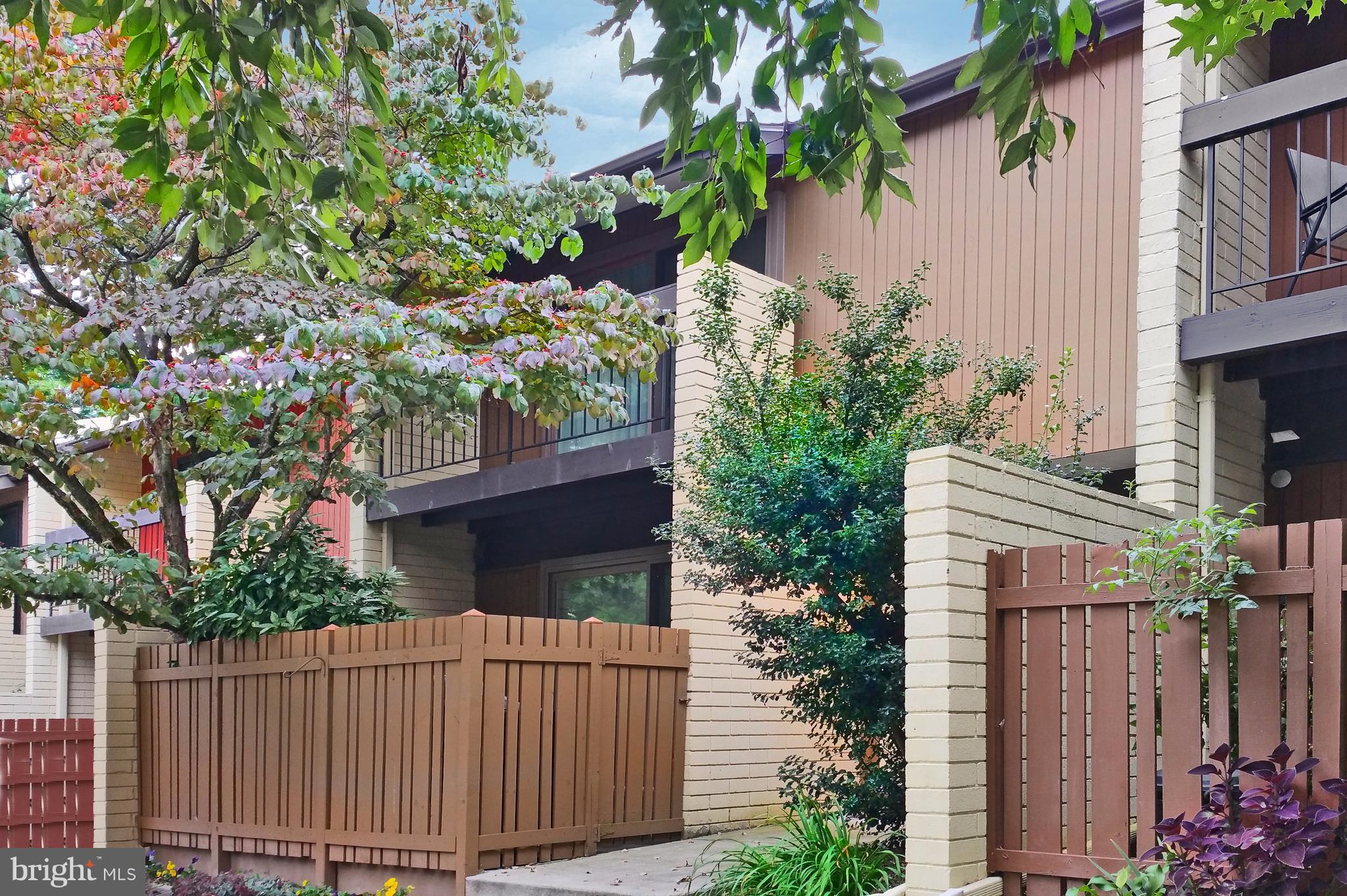 11168 Saffold Way Reston, VA 20190 - Photo 2 of 28 a front view of a house with a garden