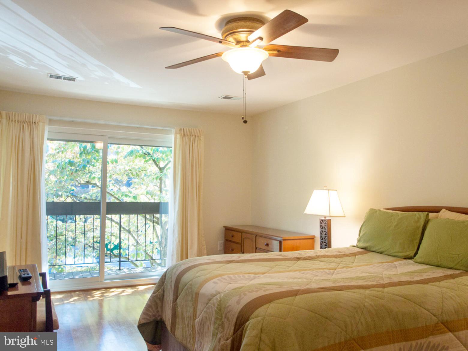 11168 Saffold Way Reston, VA 20190 - Photo 12 of 28 a bedroom with a large bed and a large window