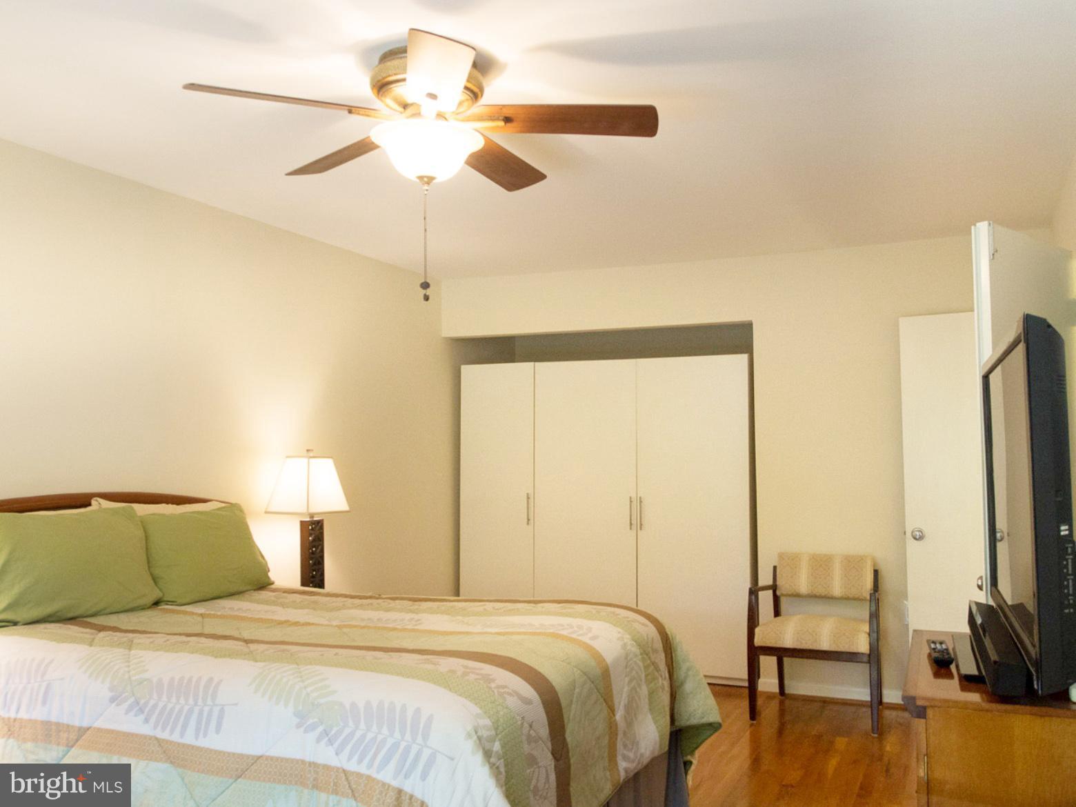 11168 Saffold Way Reston, VA 20190 - Photo 13 of 28 a bedroom with a bed and a chandelier