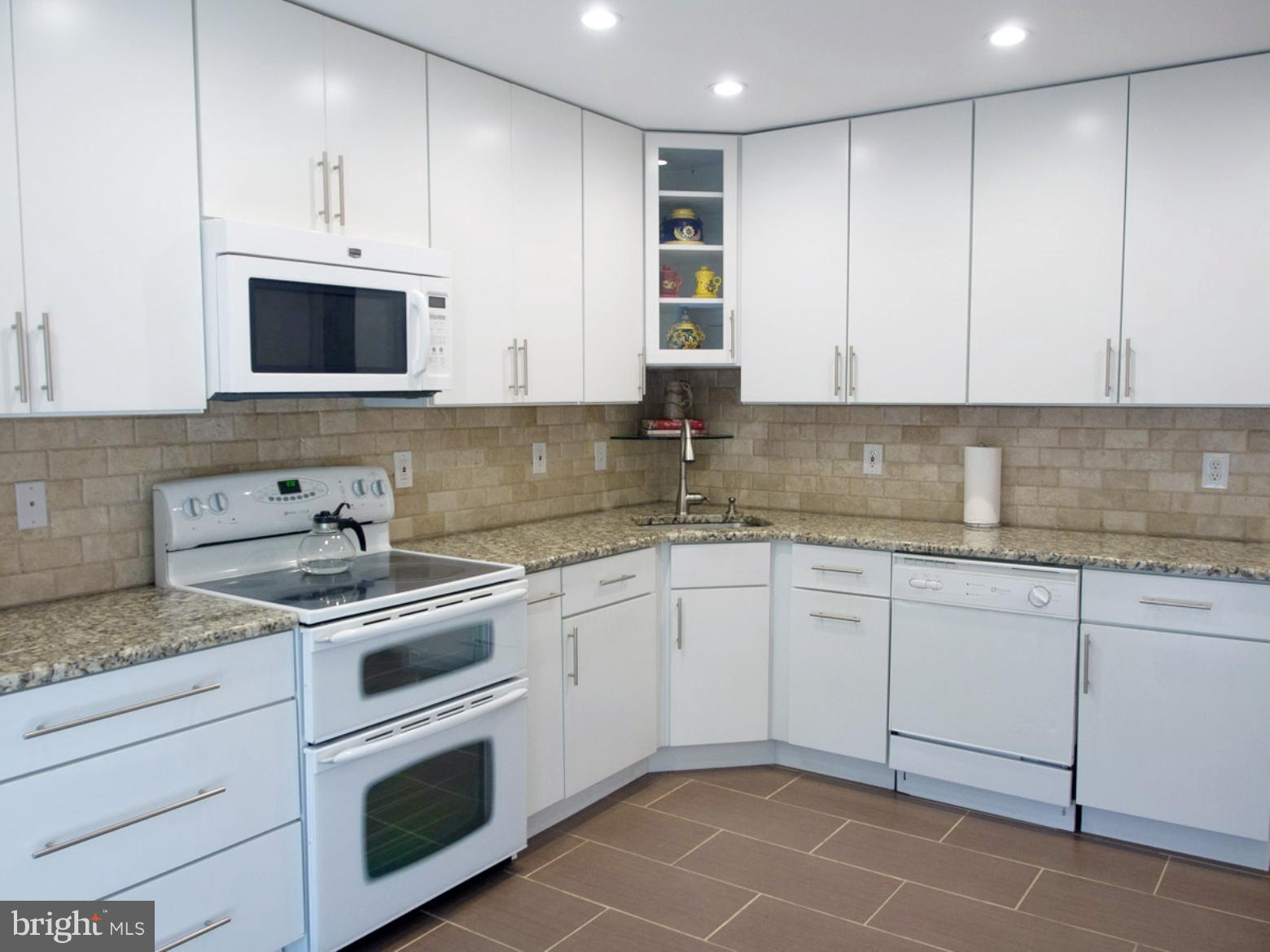 11168 Saffold Way Reston, VA 20190 - Photo 3 of 28 a kitchen with stainless steel appliances granite countertop a sink and a stove