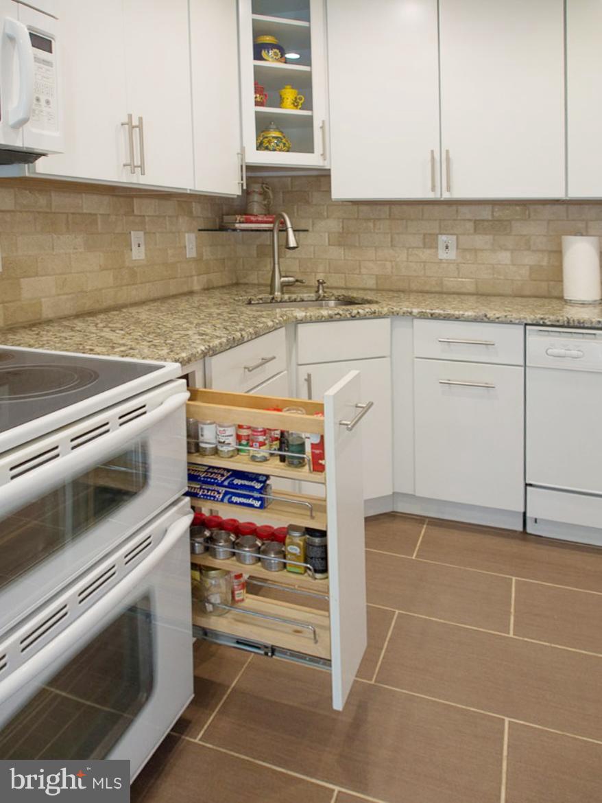 11168 Saffold Way Reston, VA 20190 - Photo 4 of 28 a kitchen with a sink and cabinets