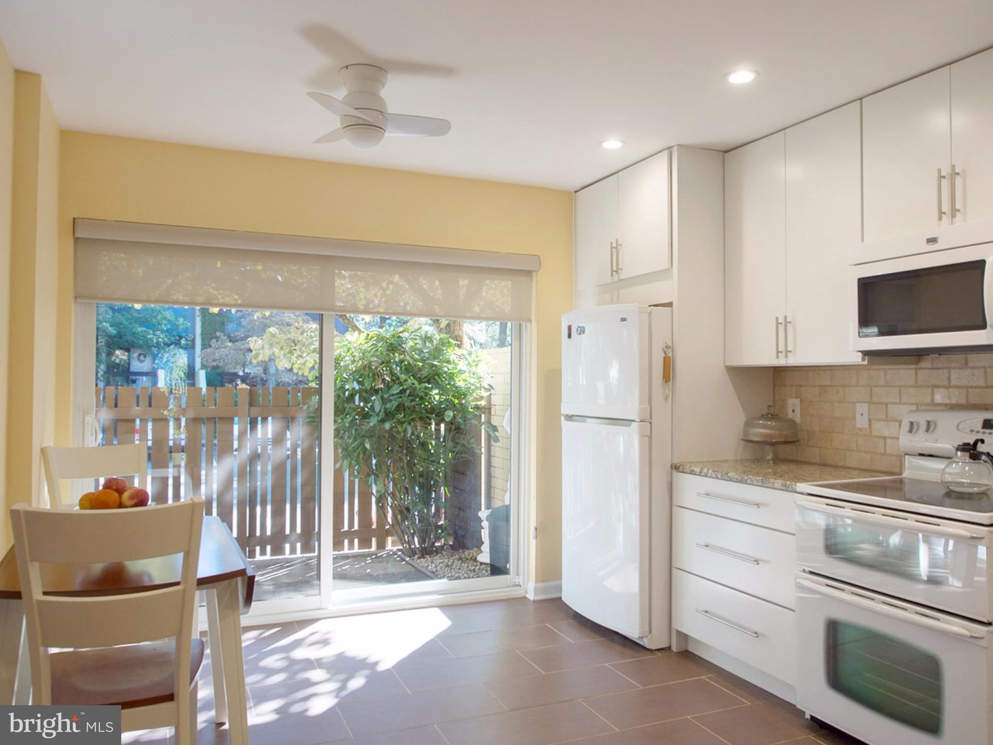 11168 Saffold Way Reston, VA 20190 - Photo 5 of 28 a kitchen with stainless steel appliances a refrigerator and a stove top oven