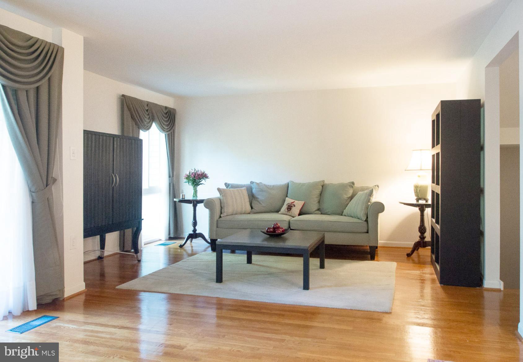 11168 Saffold Way Reston, VA 20190 - Photo 7 of 28 a living room with furniture wooden floor and a table