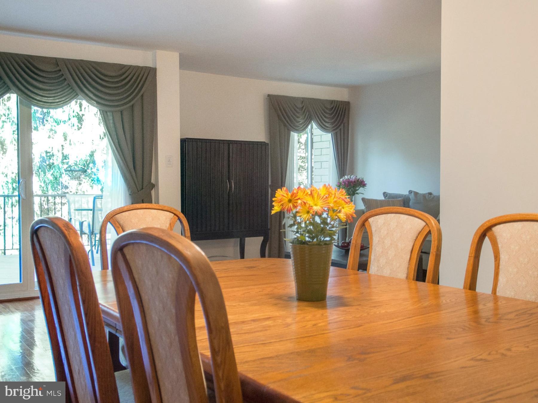11168 Saffold Way Reston, VA 20190 - Photo 10 of 28 a view of a dining room with furniture window and garden view