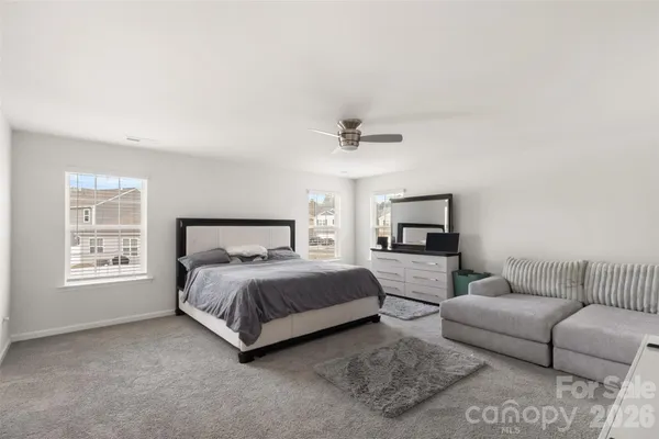 a bedroom with a bed couch and window