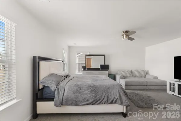 a bedroom with a bed and a couch