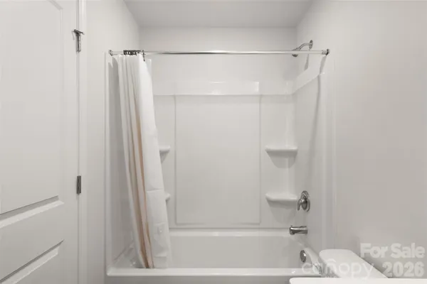 a bathroom with a shower and a bath tub