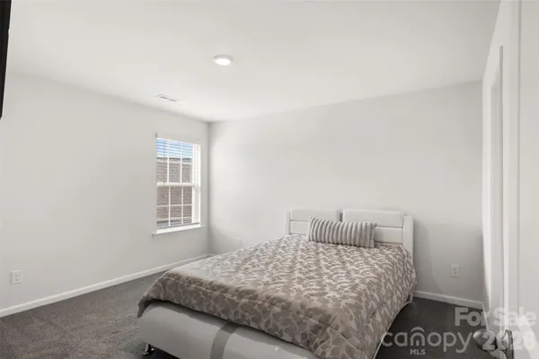 a bedroom with a bed and a window with closet
