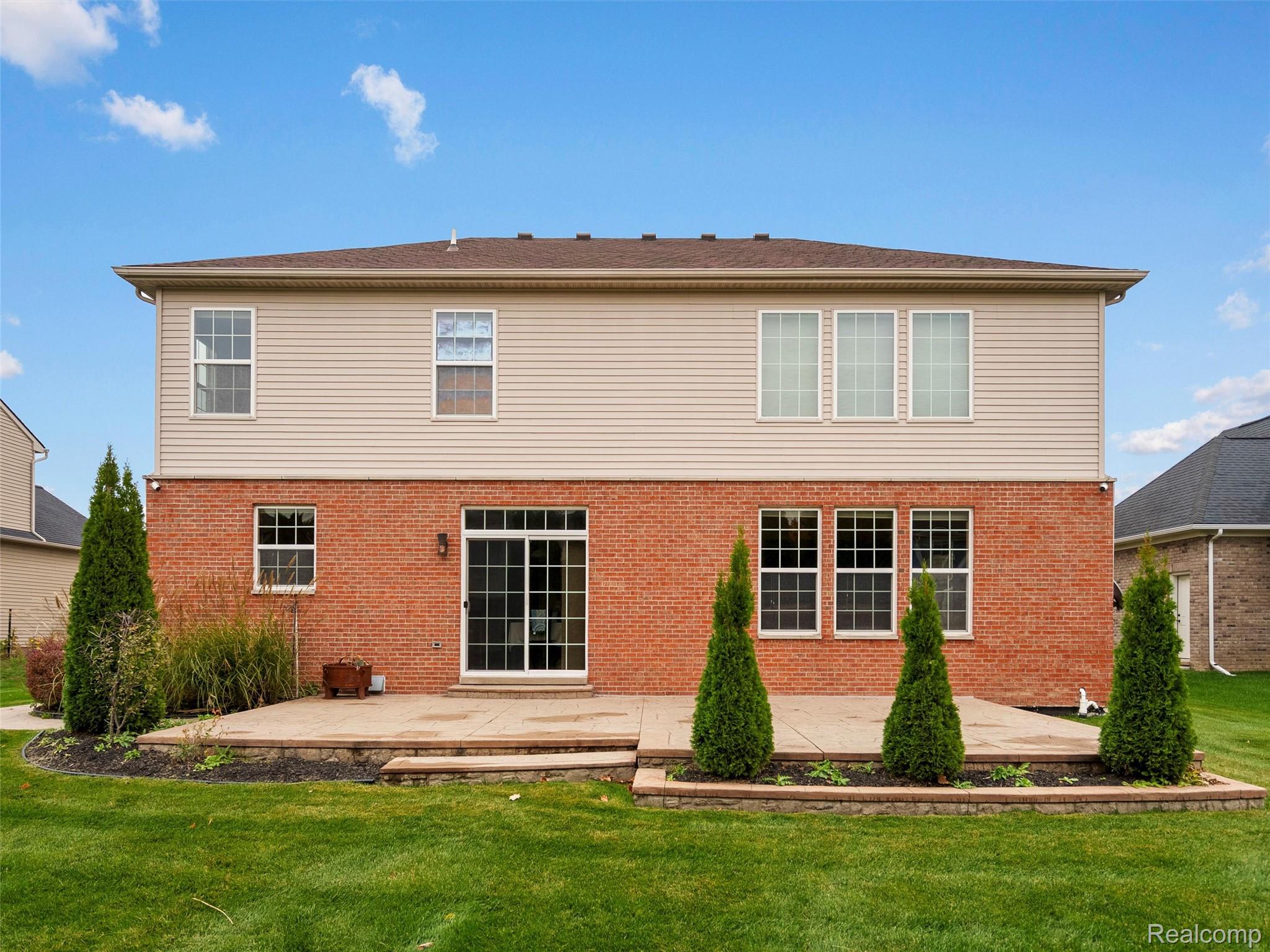 3191 Wren Lane Rochester, MI 48309 - Photo 61 of 63 Rear view of property featuring a yard, brick siding, and a wooden deck