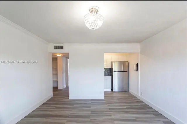 a view of a kitchen from a hallway