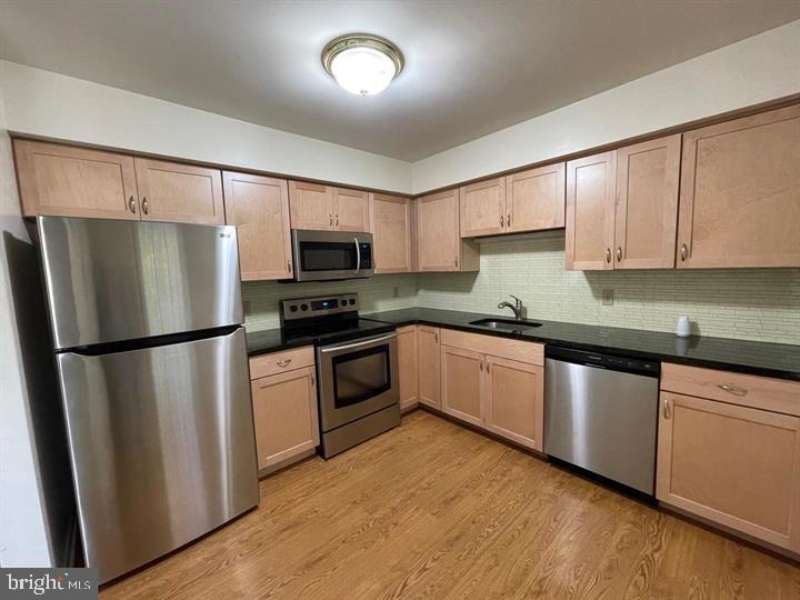 a kitchen with granite countertop a refrigerator stove and microwave