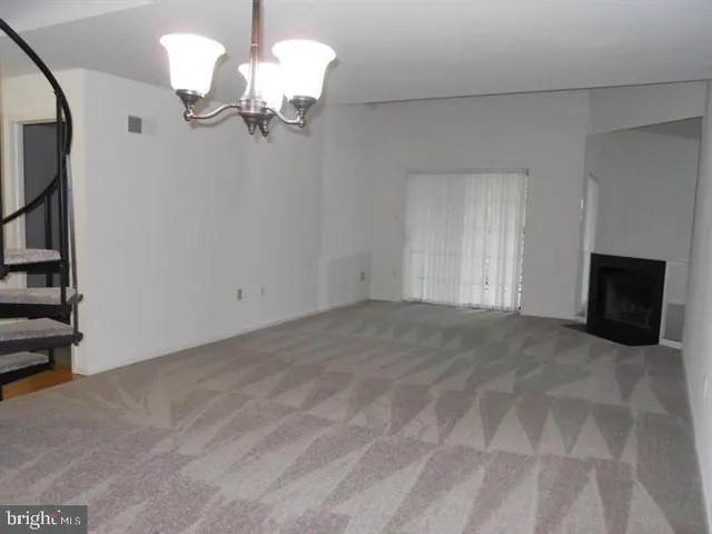 a view of a chandelier fan and entryway