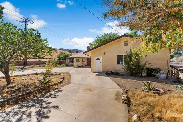 a view of a house with snow on the road