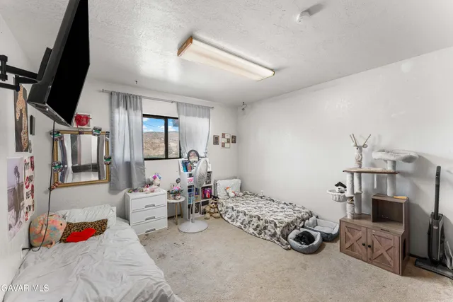 a bedroom with furniture and a flat screen tv
