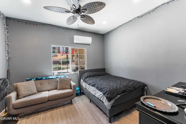 a bedroom with a bed couch and window