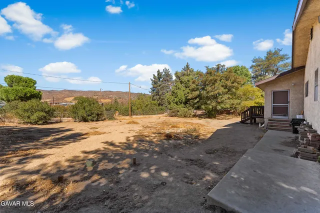 a view of a backyard of the house