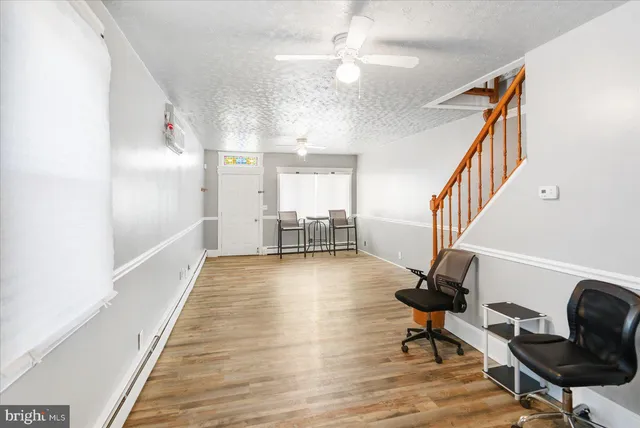 a view of a room with wooden floor and staircase