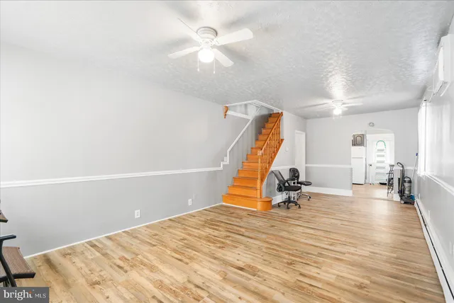 a room with wooden floor and white walls