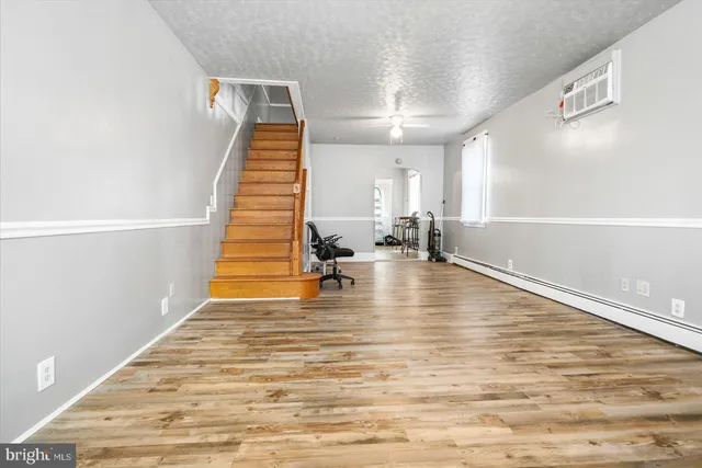 a view of a room with wooden floor and staircase
