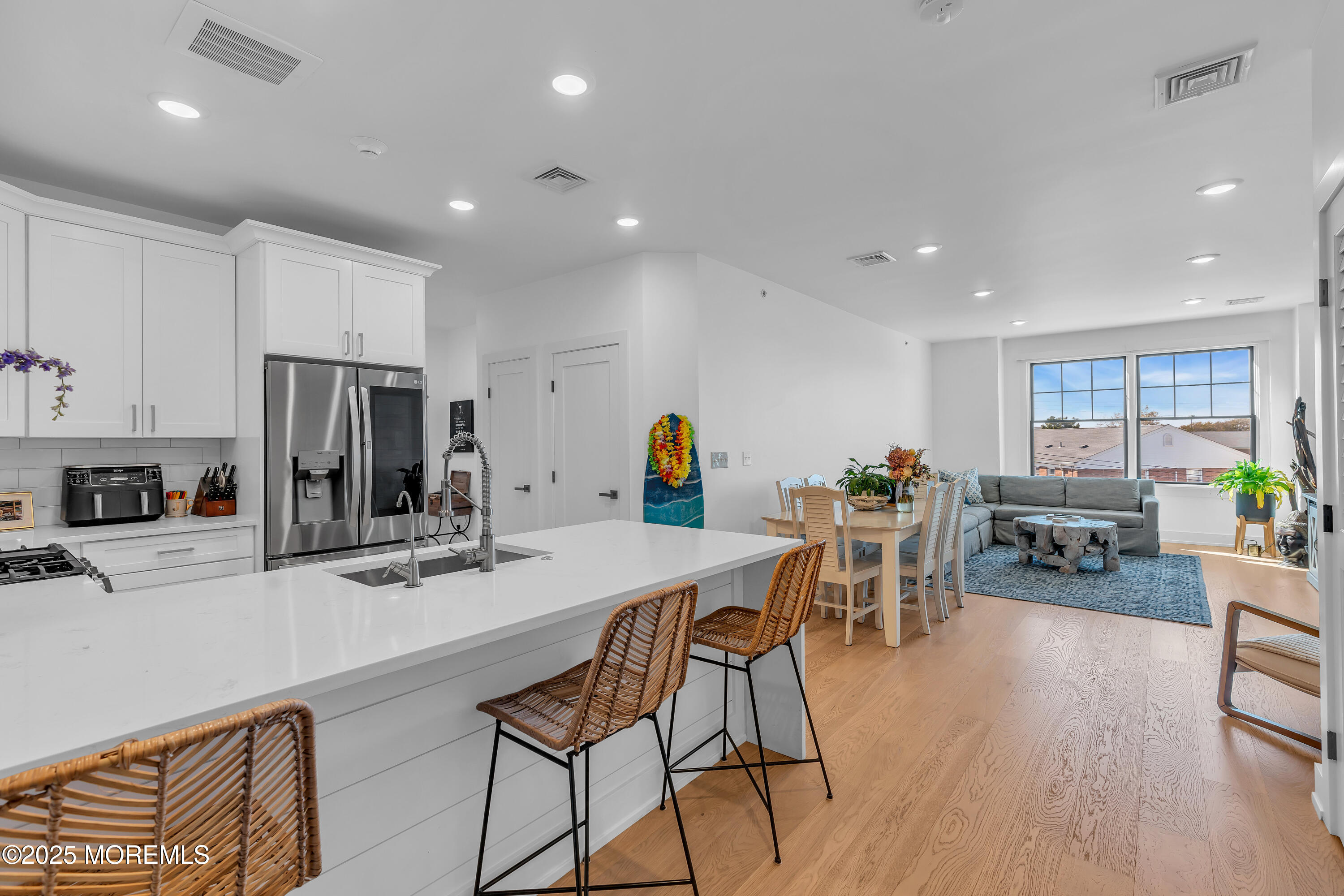 1801 Highway 35, Unit 11 Belmar, NJ 07719 - Photo 13 of 37 a kitchen with stainless steel appliances refrigerator dining table and chairs