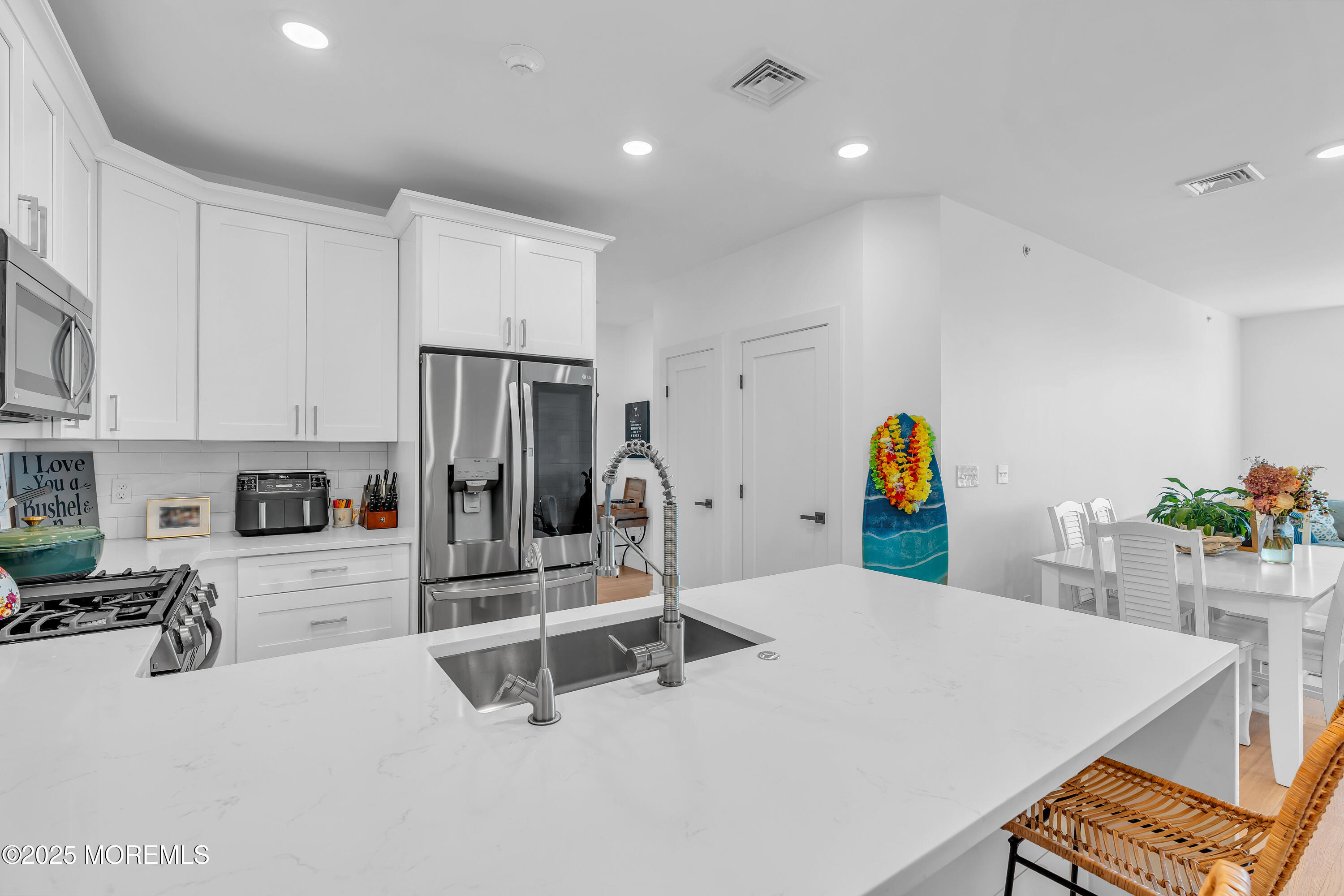 1801 Highway 35, Unit 11 Belmar, NJ 07719 - Photo 14 of 37 a kitchen with stainless steel appliances a sink and a table