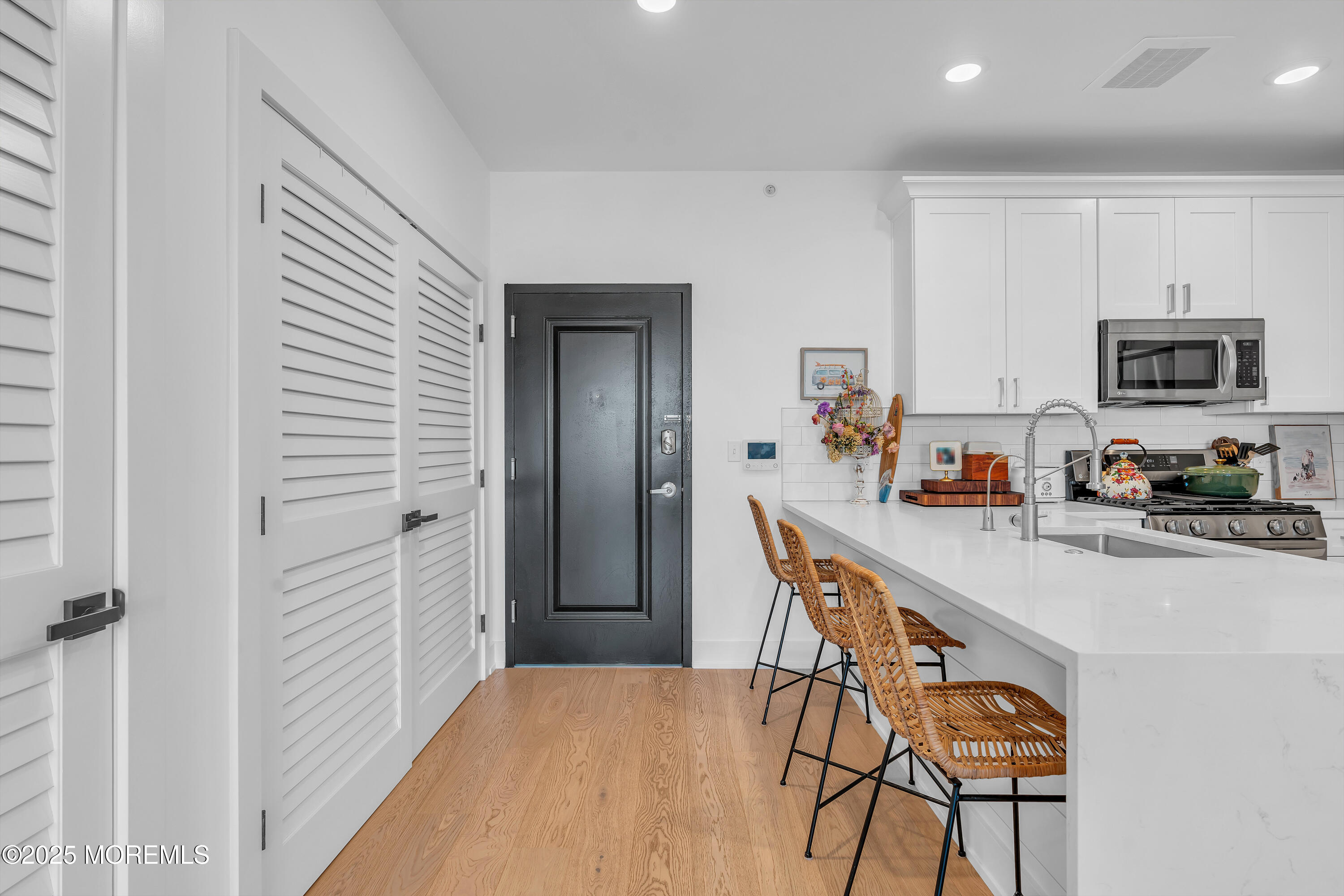 1801 Highway 35, Unit 11 Belmar, NJ 07719 - Photo 16 of 37 a kitchen with stainless steel appliances granite countertop a refrigerator and microwave