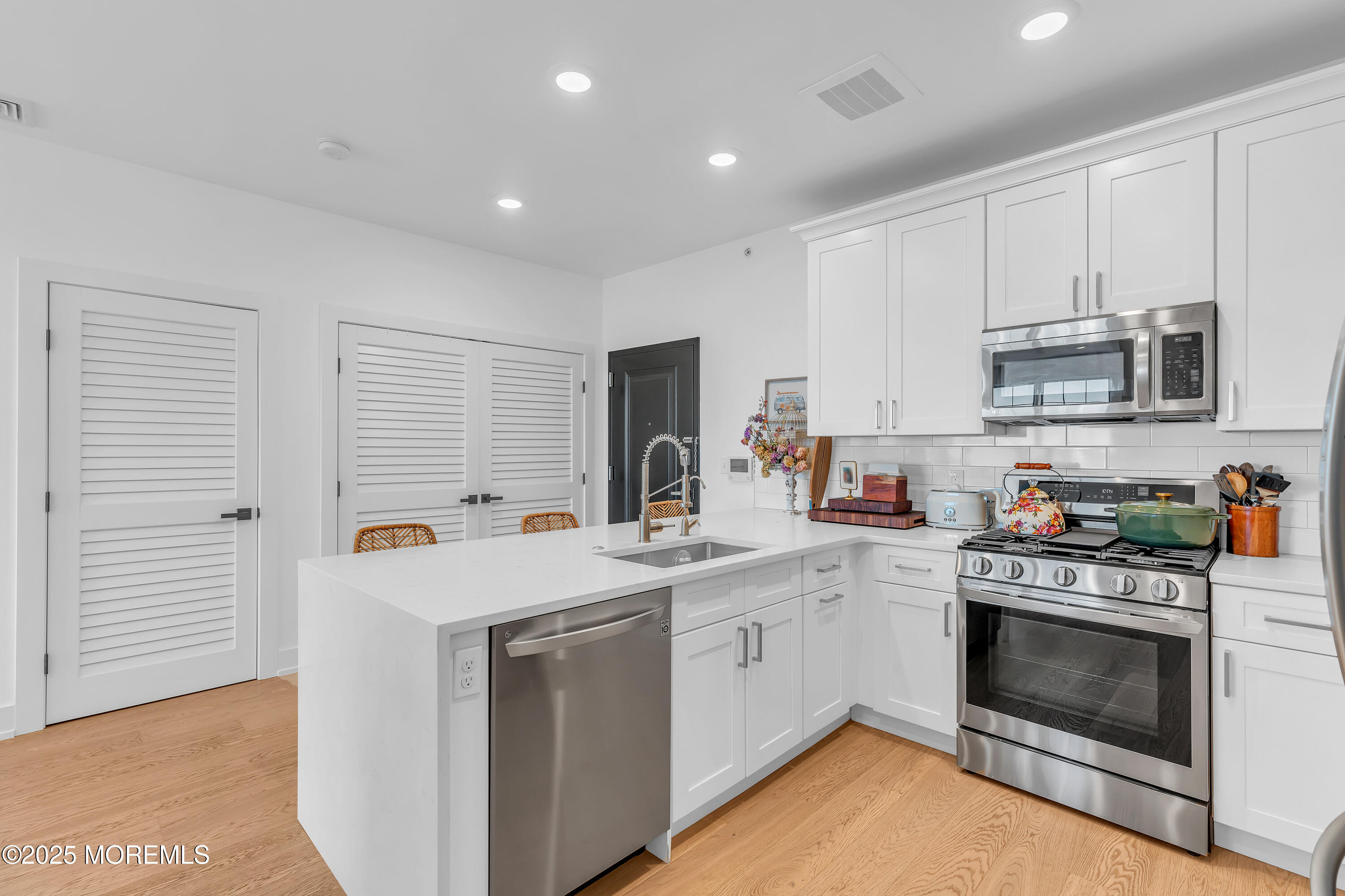 1801 Highway 35, Unit 11 Belmar, NJ 07719 - Photo 20 of 37 a kitchen with a stove sink and a microwave