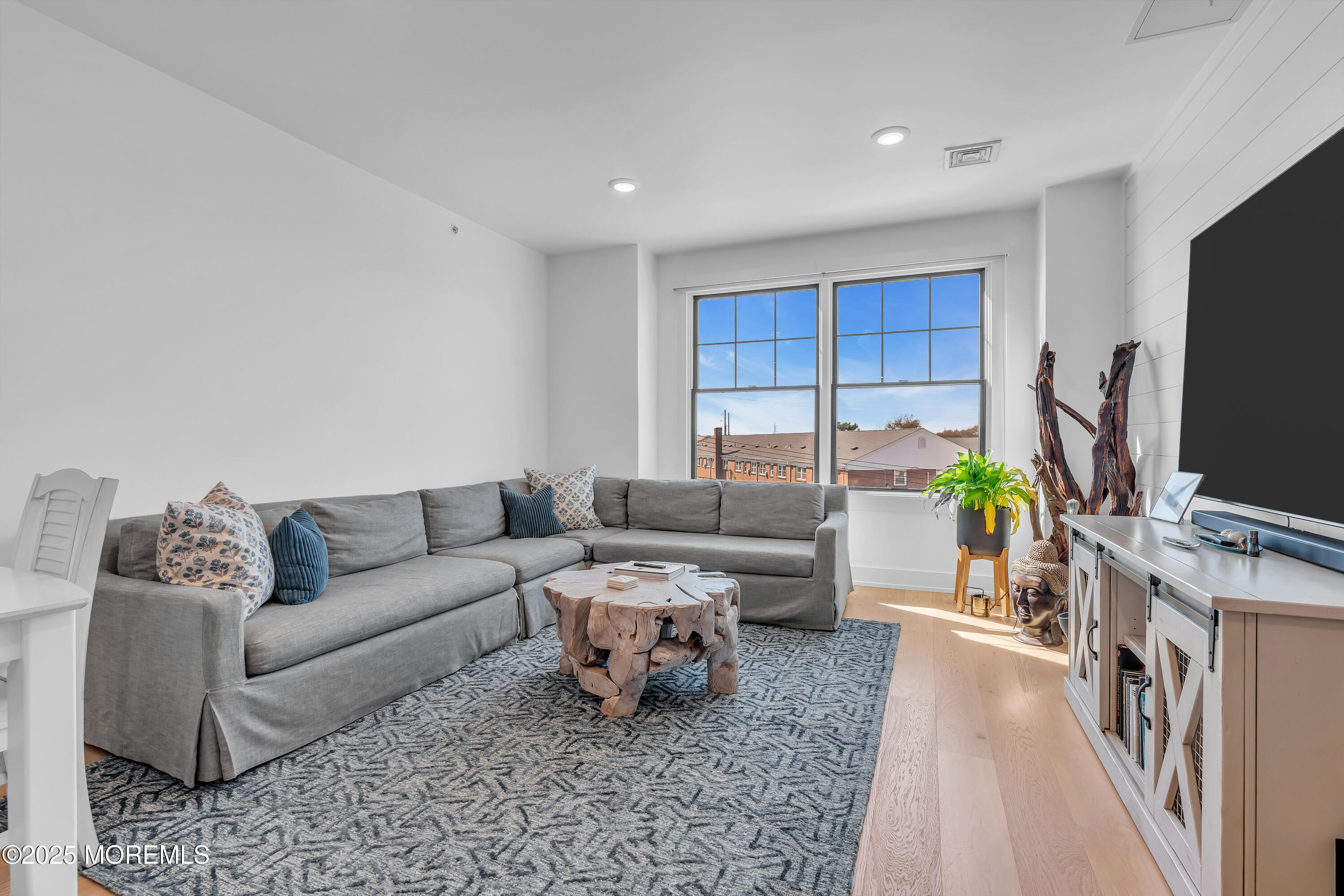 1801 Highway 35, Unit 11 Belmar, NJ 07719 - Photo 27 of 37 a living room with furniture and a flat screen tv