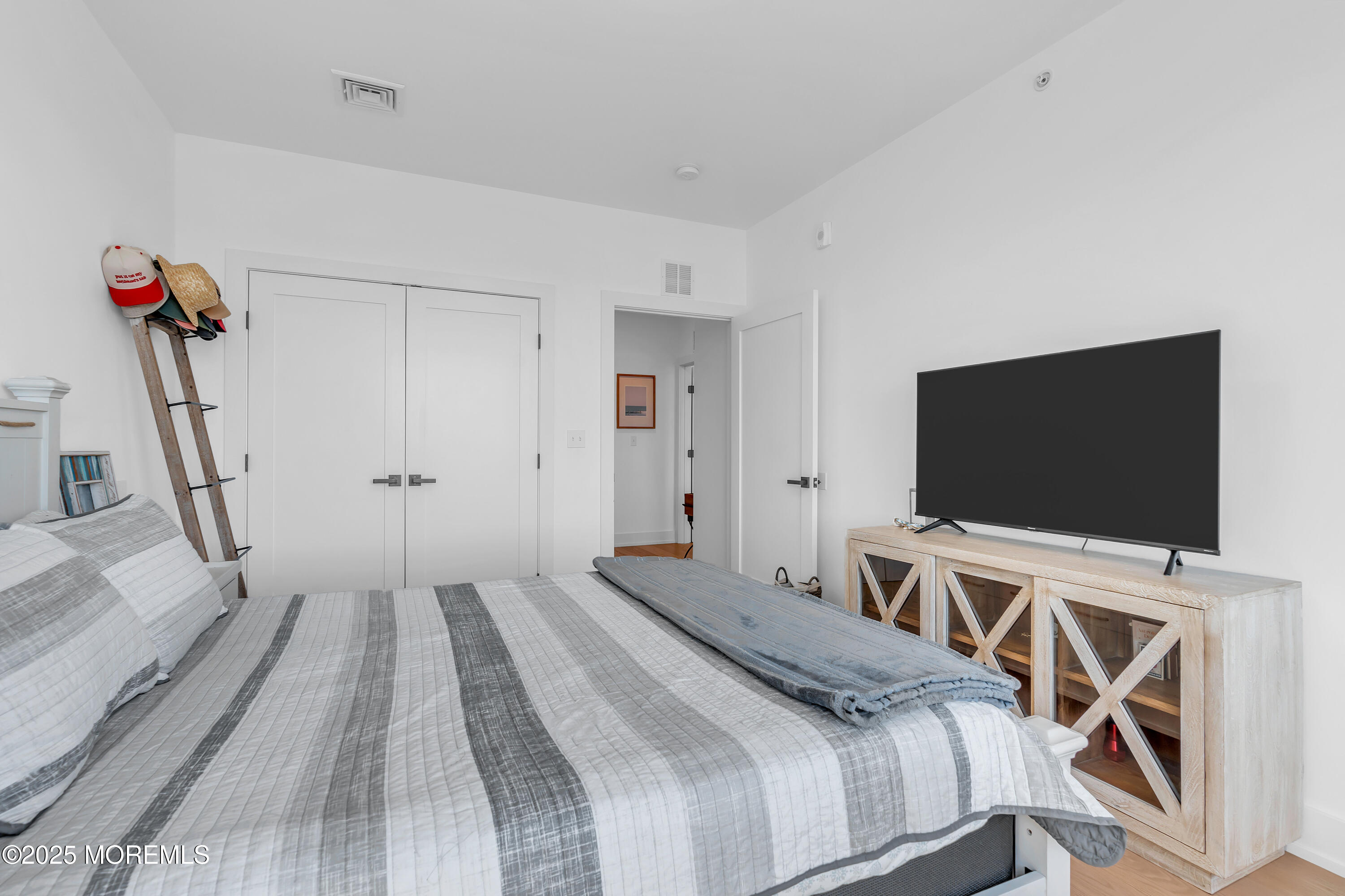 1801 Highway 35, Unit 11 Belmar, NJ 07719 - Photo 29 of 37 a bedroom with a bed and a flat screen tv