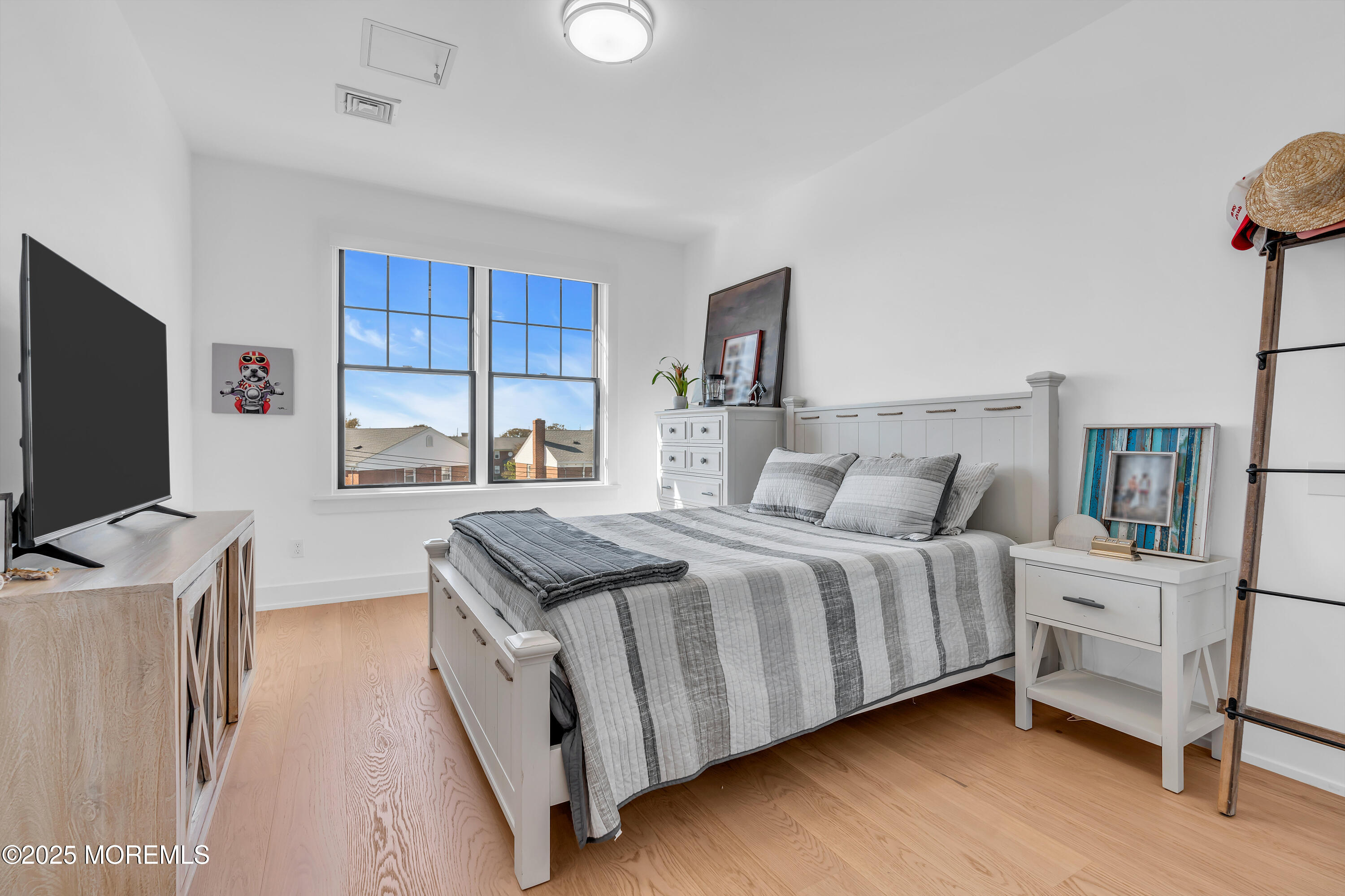 1801 Highway 35, Unit 11 Belmar, NJ 07719 - Photo 30 of 37 a bedroom with a bed and a flat screen tv