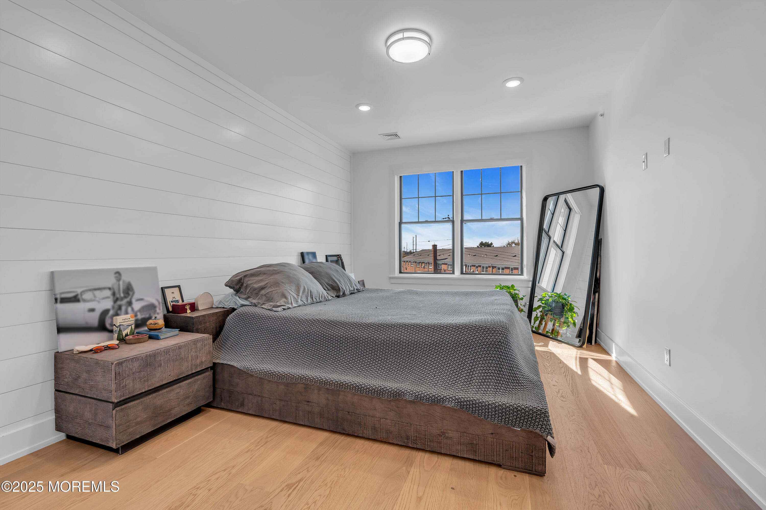 1801 Highway 35, Unit 11 Belmar, NJ 07719 - Photo 32 of 37 a spacious bedroom with a bed a couch and a window
