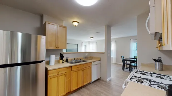 a kitchen with stainless steel appliances a refrigerator and a stove top oven