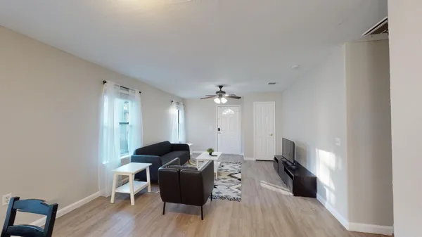 a living room with furniture and a flat screen tv