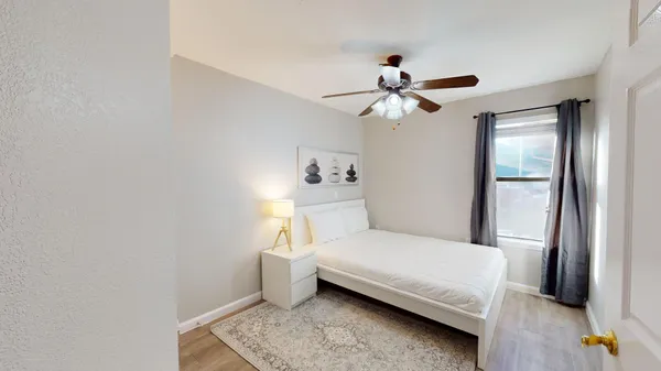 a bedroom with a bed and a chandelier