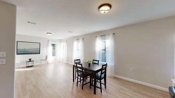a view of a dining room with furniture and wooden floor