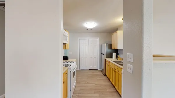 a view of a kitchen from the hallway