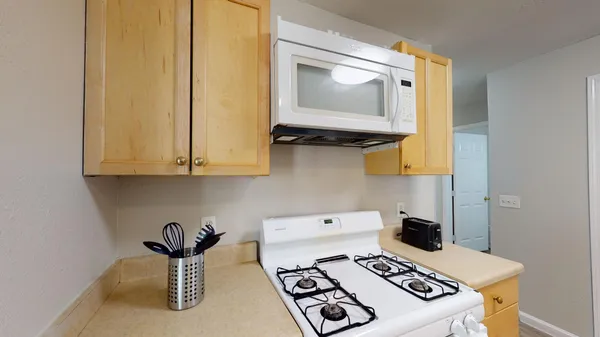 a kitchen with a stove and a microwave
