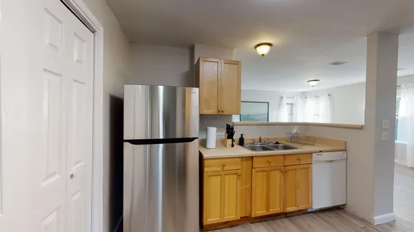 a kitchen with a refrigerator sink and cabinets