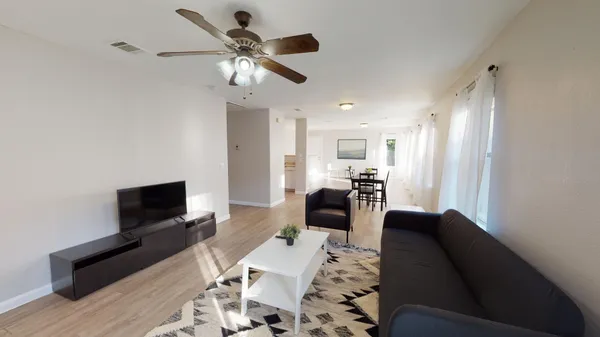 a living room with furniture and a flat screen tv