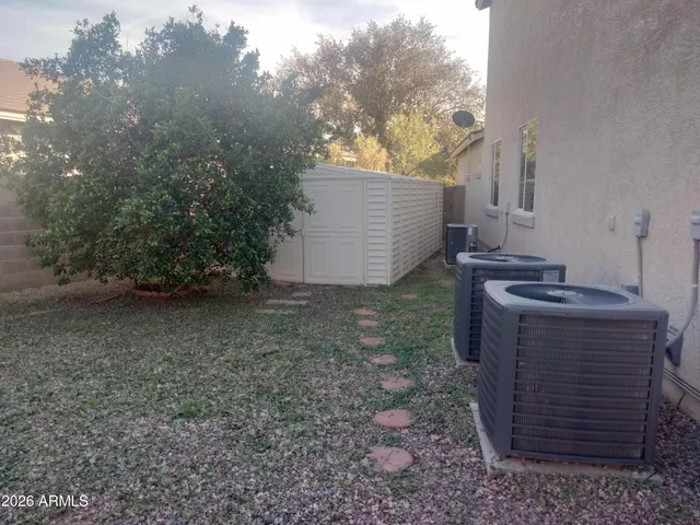 a view of house with backyard space and garden
