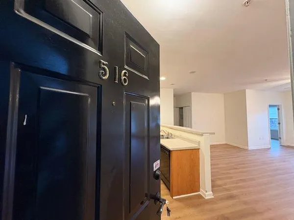 a view of a hallway with wooden floor