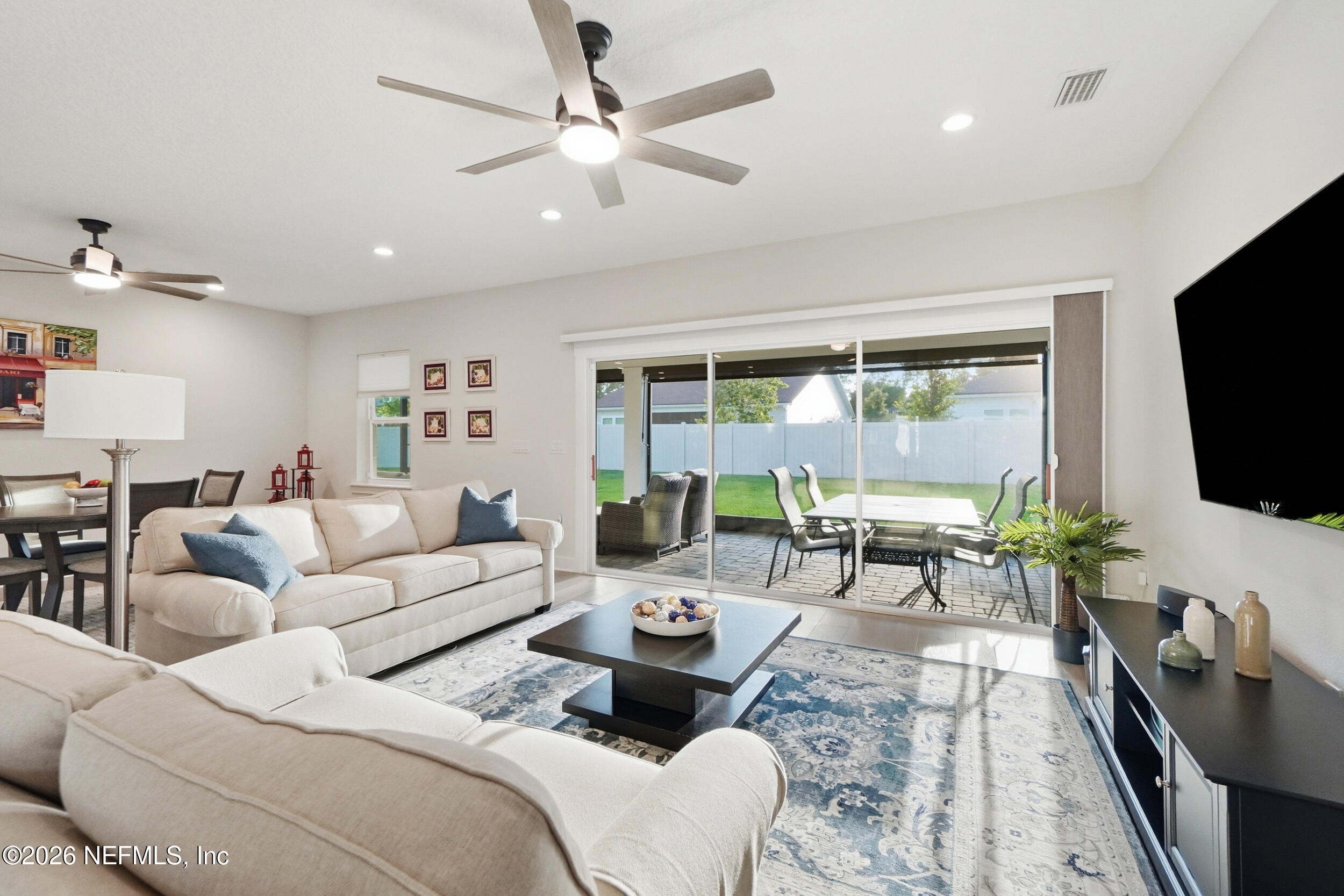 34 Red Rock Lane St. Johns, FL 32259 - Photo 22 of 71 a living room with furniture a flat screen tv and a large window