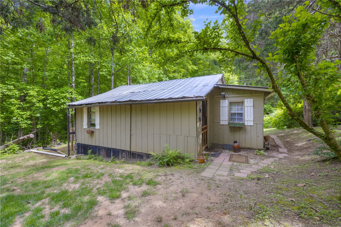 437 West Gate Road Pickens, SC 29671 - Photo 20 of 47 This charming cabin is nestled amongst lush trees, offering a tranquil retreat.